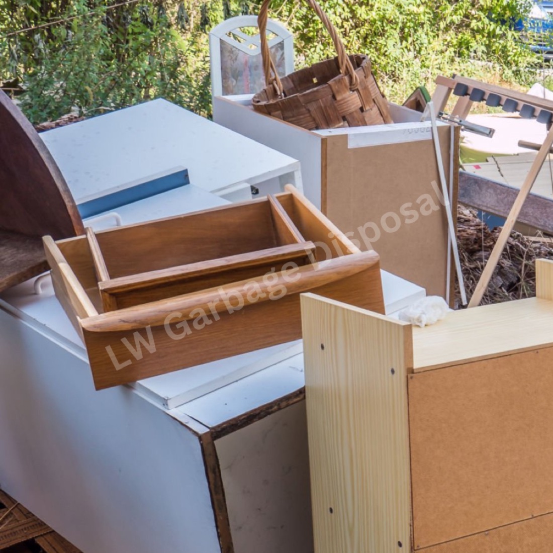 LW Garbage Disposal crew lifting a heavy dresser during a Laguna Woods furniture removal