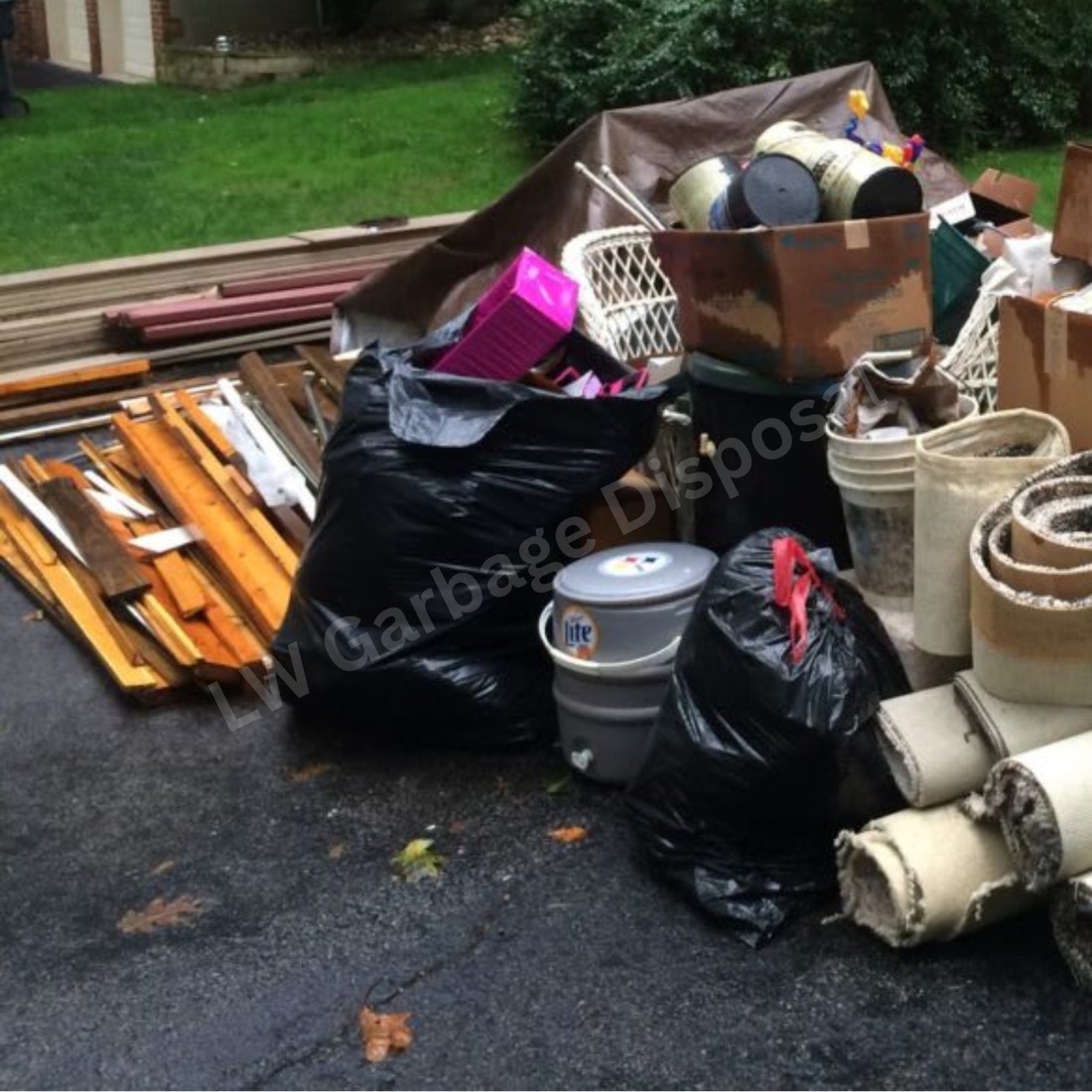 Junk removal truck being loaded with household items in a Laguna Woods neighborhood